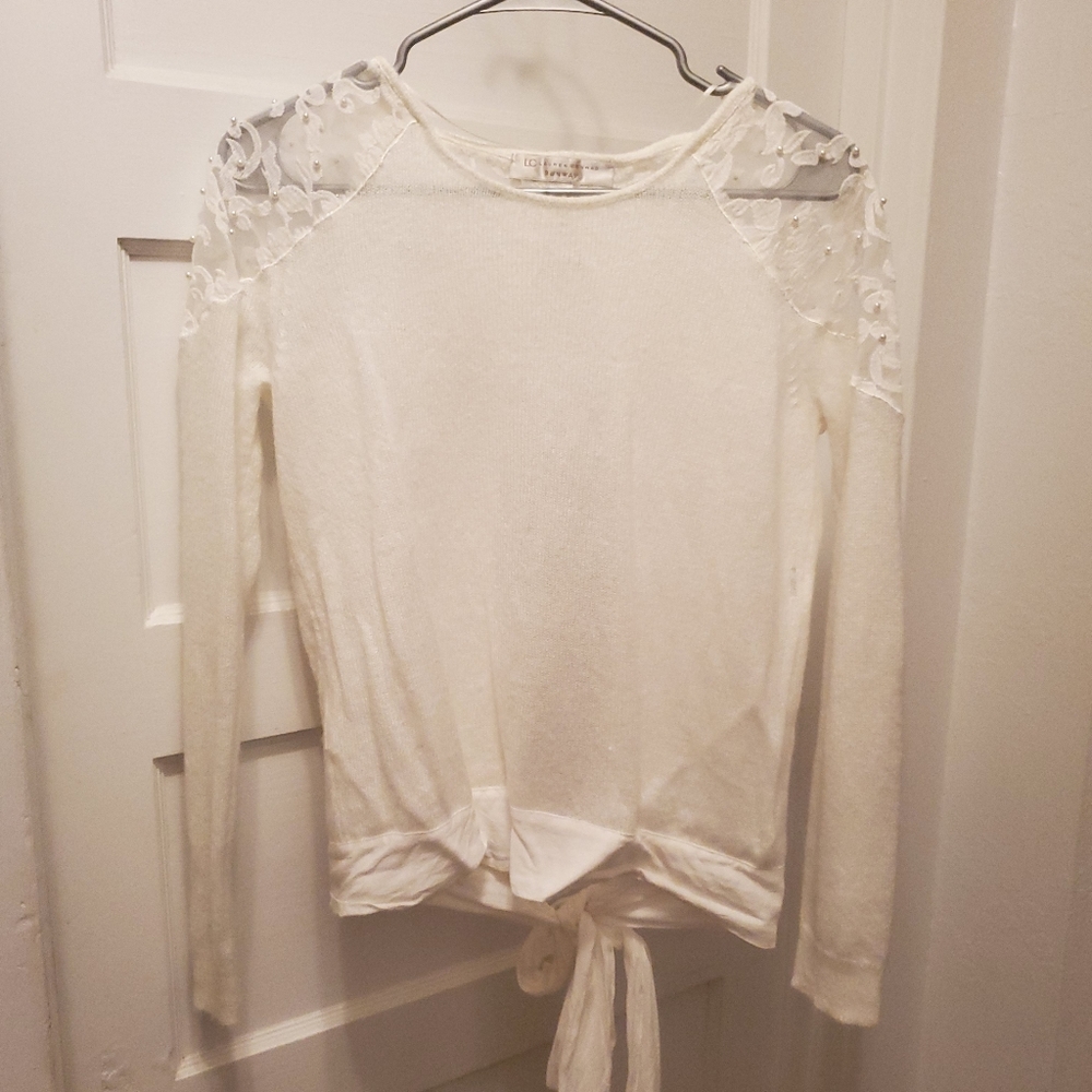 White shirt with open back and tie.